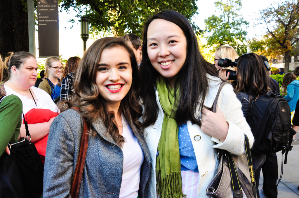 A picture of two women at the priesthood action, smiling at the camera